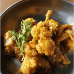 A small portion of stir-fried potato and cauliflower