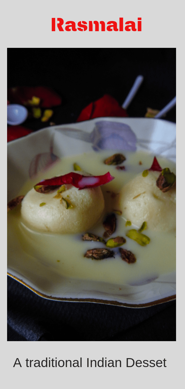 Sweet rasgulla dipped in thickened milk and garnished with rose, pistachios and saffron