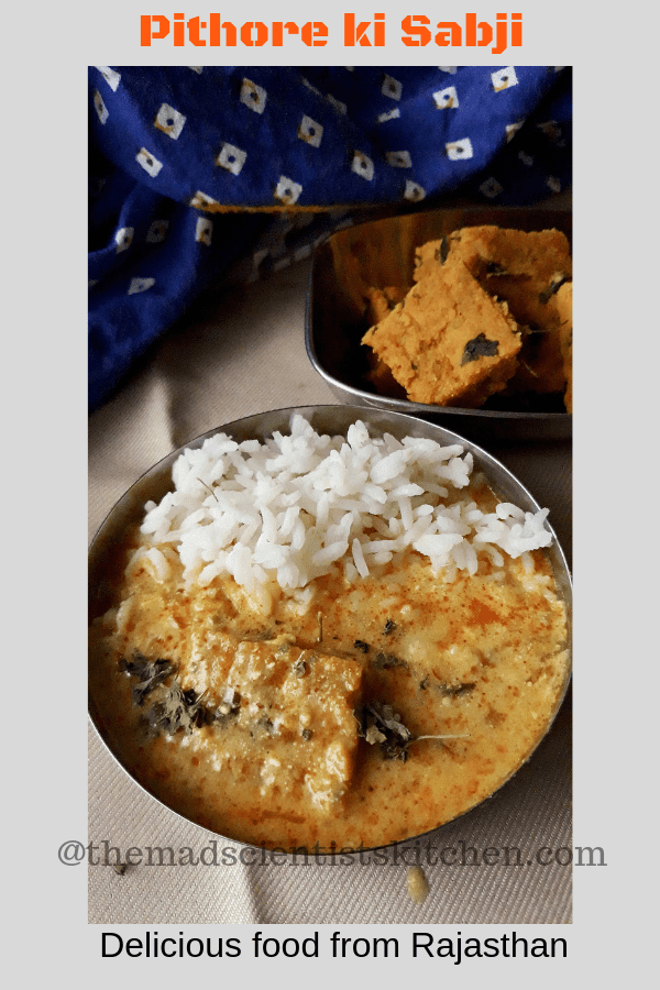 Rice and Pithore ki kadhi in a small bowl. A serving of pithore can also been seen.