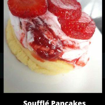 soufflé pancake topped with whipped cream, strawberry compote and strawberries
