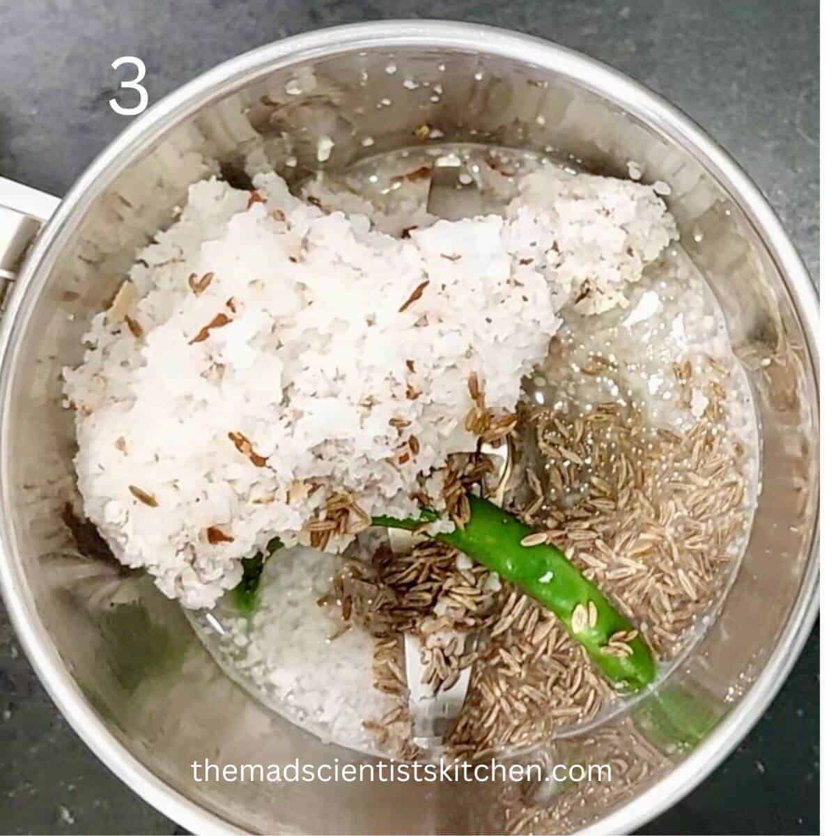 Grinding fine the coconut, chillies and cumin seeds in water.