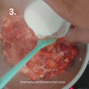 Adding cornflour slurry to thicken the strawberry sauce