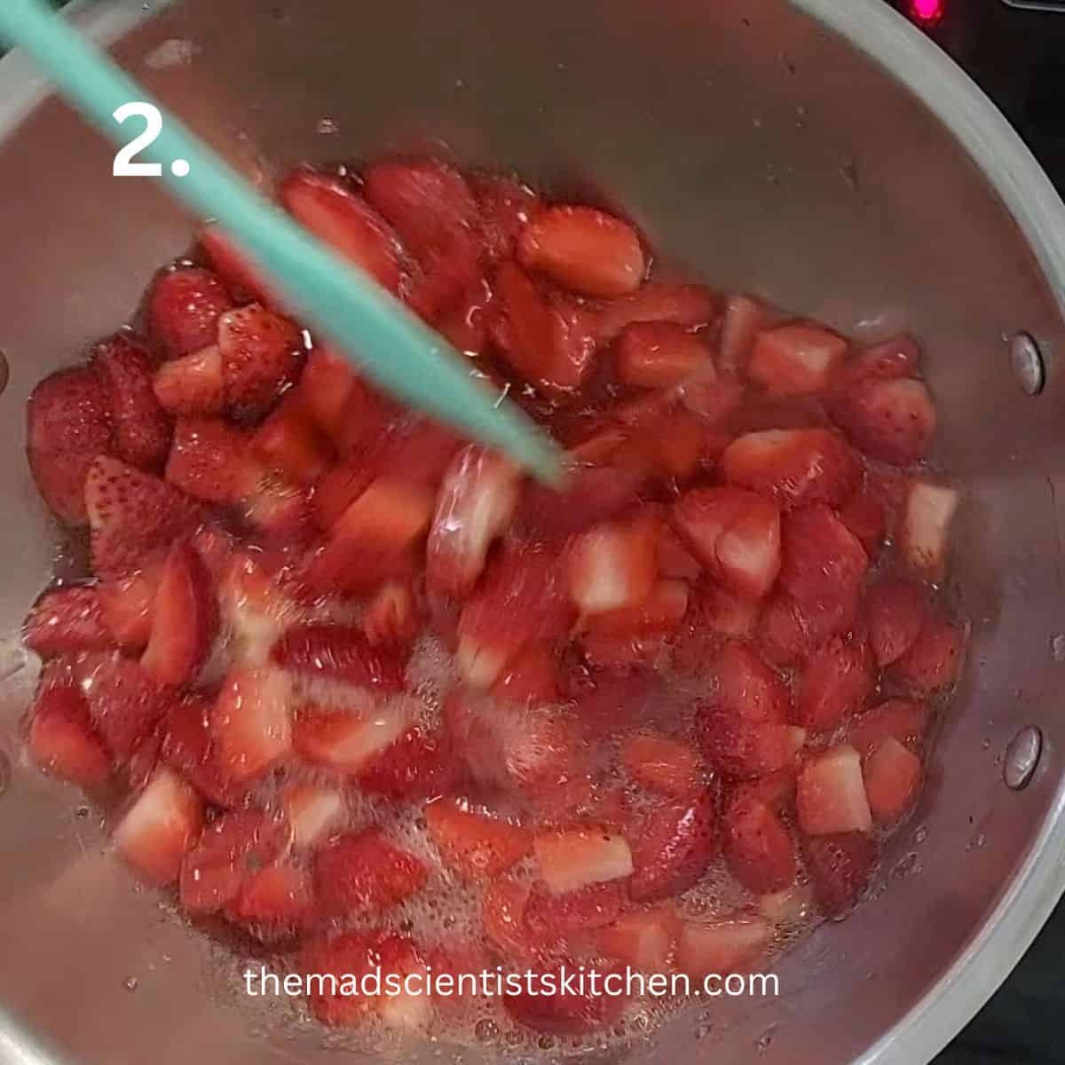 Cooking the berries for strawberry sauce