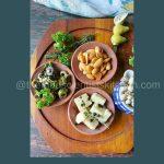 Delicious tapas spread showcasing a delightful combination of cheese, almonds, and marinated olives for a perfect appetizer experience.