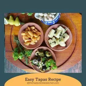 A tempting array of tapas featuring a mix of cheese, almonds, and marinated olives on a rustic platter.