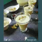Chilled glass of creamy Shahi Shikanji with saffron and dry fruit garnish