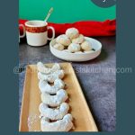 Crescent Kourabiedes buttery Greek cookies coated with snowy icing sugar.