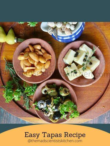 A tempting array of tapas featuring a mix of cheese, almonds, and marinated olives on a rustic platter.